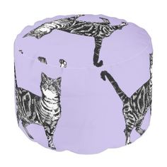 a pink stool with zebras on it and one cat standing in the middle of the photo