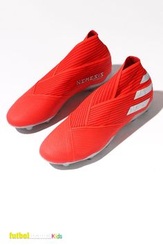 a pair of red soccer shoes on a white background