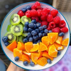 a white bowl filled with different types of fruit