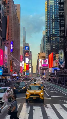 taxi cabs driving down a busy city street