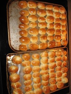 two pans filled with baked goods sitting on top of a stove