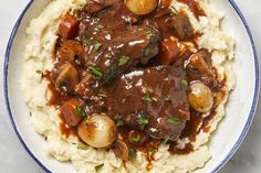 a white plate topped with mashed potatoes and beef