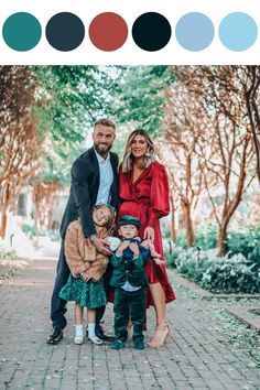 a family posing for a photo in front of some trees with color swatches on them