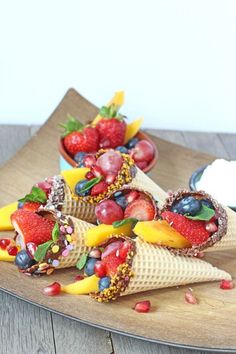 some fruit and ice cream cones are on a plate