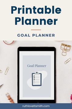 a tablet with the text printable planner goal planner on it next to office supplies