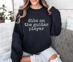 This Dibs On The Guitar Player Sweatshirt is the perfect gift for a cute guitarist. It gives off a fun and playful vibe, making it great for casual wear or lounging around. Ideal for music lovers, guitar enthusiasts, and anyone who appreciates a good pun. Perfect for birthdays, holidays, music events, or just because! Product features - Knit in one piece without side seams for reduced fabric waste - Ribbed knit collar with seam for added elasticity and shape retention - Made with a cozy medium-h The Guitar, Holidays Music, Guitar Teacher Gifts, Guitar Lover Gifts, Guitarist Gifts, Guitar Lover, Guitar Teacher, Best Puns, Guitar Lovers