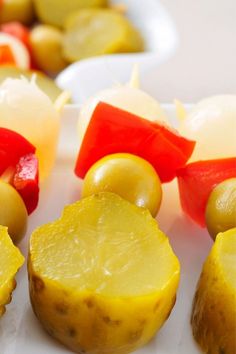 some food is on a white plate and ready to be eaten with other foods in the background