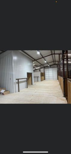 the inside of a building with lots of wood floors and metal buildings on both sides