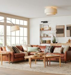 a living room filled with furniture and lots of windows