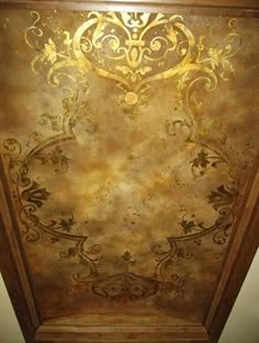 an ornate gold painted ceiling in a room