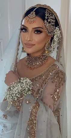 a woman wearing a bridal gown and veil