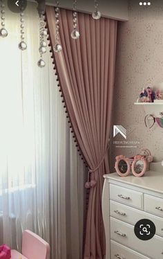 a bedroom with pink furniture and curtains