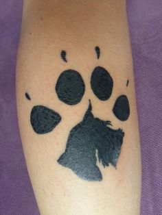 a dog's paw with black ink on the leg and it looks like an animal