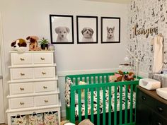 a baby's room with three pictures on the wall and a green crib