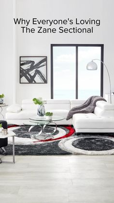 a living room with white furniture and large windows