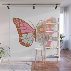 a wall mural with a butterfly and flowers on it in the corner of a room