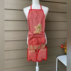 a mannequin wearing an apron with gingerbread cookies on it