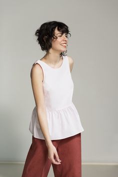 This airy top is handmade from pure cotton-poplin, has a pleated peplum waist and a beautifully folded plunge back. The loose A-shape and elegant neckline make for a versatile and effortless design and feel. Like all our pieces, this cotton top is carefully crafted - it has French seams and bias tape finishing. The top is easily combined with crop tops, sweaters and blouses. Item: Handmade and made to order Material: 100% cotton poplin, OEKO-TEX® certified Fit: Relaxed Style: Casual/Formal Sleeves: Sleeveless Pockets: No Back: Open Colors:       - White       - Black       - Navy Blue       - Pink       - Light Blue If you'd love to have this top in a different color or size, we'd be happy to custom-make one for you.  Feel free to contact us at any time with questions and suggestions! We a Affordable Chic Sleeveless Peplum Top, Cotton Peplum Top, Black Ruffle Top, Ruffle Trim Top, Statement Skirt, Light Blue Top, Comfortable Office, Evening Skirts, Pretty Top