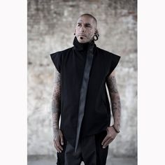 Black denim sleeveless jacket designed with vegan leather stripes. High neck closure and 2 side pockets. On the picture combined with our Hecto Pants. The model on the picture is wearing size M. His height is 181. Collection 'DEMON' 21 Fitted Urban Vest For Streetwear, Edgy Black Vest For Streetwear, Alternative Black Vest For Streetwear, Black Alternative Style Vest For Streetwear, Black Alternative Streetwear Vest, Cyberpunk Coat, Gothic Boutique, Outfit Grid, Style Noir