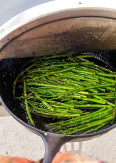 asparagus being cooked in a pan on the stove