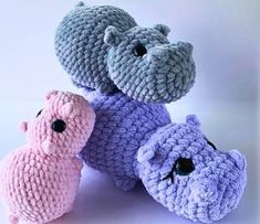 three crocheted stuffed animals sitting next to each other