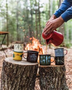 someone is pouring coffee into their mugs in front of a campfire with the caption