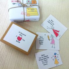 four personalized note cards with writing on them next to a wrapped present box and wrapping paper