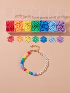 bracelets and beads are arranged on a pink surface with plastic storage containers for them