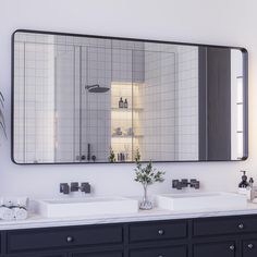 a bathroom with two sinks and a large mirror on the wall over it's sink