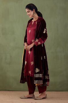 Maroon kurta with floral foil print and zig-zag detail. Paired with salwar and silk velvet foil print shawl.
Component: 3
Pattern: Foil Print
Type Of Work: Floral
Neckline: Notched
Sleeve Type: Long Sleeves
Fabric: Mashru, Silk Velvet
Color: Maroon
Other Details: 
Foil print
Silk velvet shawl
Occasion: Wedding - Aza Fashions Velvet Shawl, Kurta Set For Women, Types Of Work, Luxury Sale, Velvet Color, Kurta Set, Silk Velvet, Foil Print, Set For Women