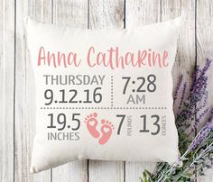 a personalized birth pillow with the birth date and baby's footprints on it