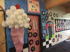 a room decorated with balloons and decorations in the shape of an ice cream shop door