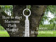 a macrame plant hanger hanging from a tree in the grass with text overlay that reads, how to start macrame plant hanger 3 ways wrap the ring