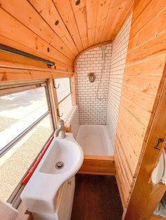 a bathroom with a sink, tub and window