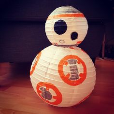 a paper lantern shaped like a star wars bbg character sitting on a wooden table