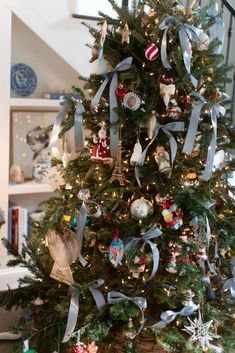 a decorated christmas tree with ribbons and ornaments