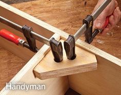 a man is working with tools on a piece of wood