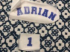 two pieces of fabric with the name adrian on them