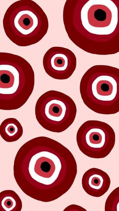 red and white circles with black dots are on a pink background that is very similar to the same pattern