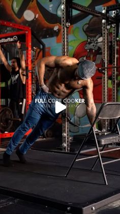 a shirtless man doing a handstand on top of a chair in front of a colorful wall