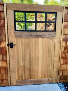 a wooden door with black glass on it