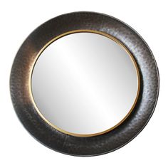 a round metal mirror with gold trim around it