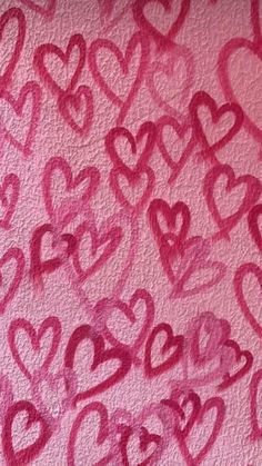 the pink wall has hearts drawn on it