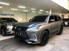 two suvs are parked in a parking garage