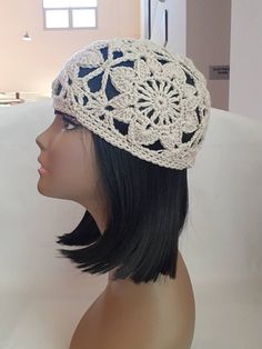 a mannequin head wearing a white crochet hat