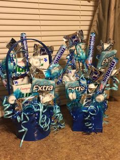 two vases filled with candy and wrapped in blue ribbon are sitting on the counter