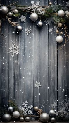 a wooden background with snowflakes and christmas balls on it's sides, as well as an ornament