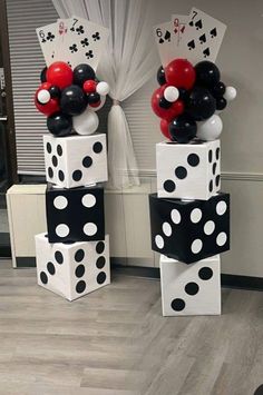 some black and white polka dot balloons are stacked on top of each other in the shape of dices