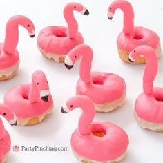 donuts with pink frosting and flamingos on them are arranged in the shape of doughnuts