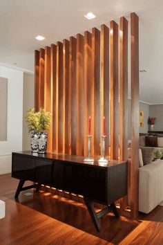 a living room with wood paneling and candles on the table in front of it